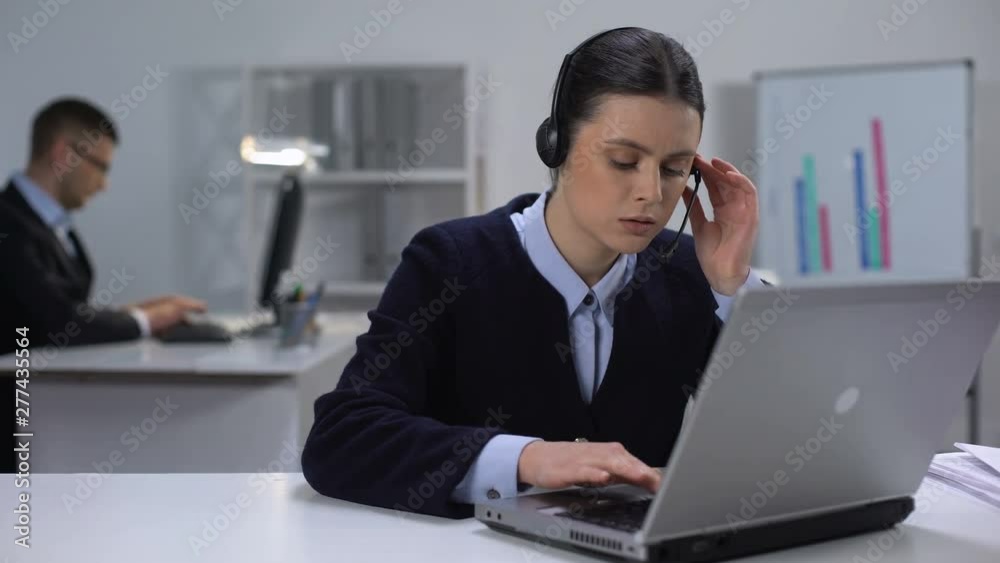 Call center manager in headset checking data on laptop, customer support Call center manager in headset checking data on laptop, customer support
