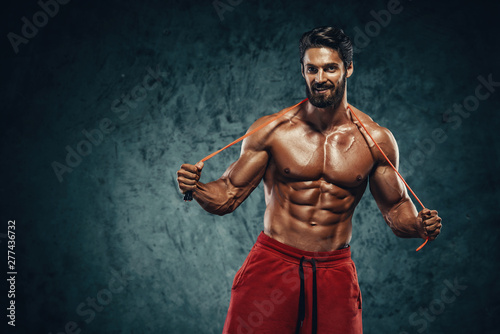 Handsome Athletic Man Posing With Jump , Skipping Rope