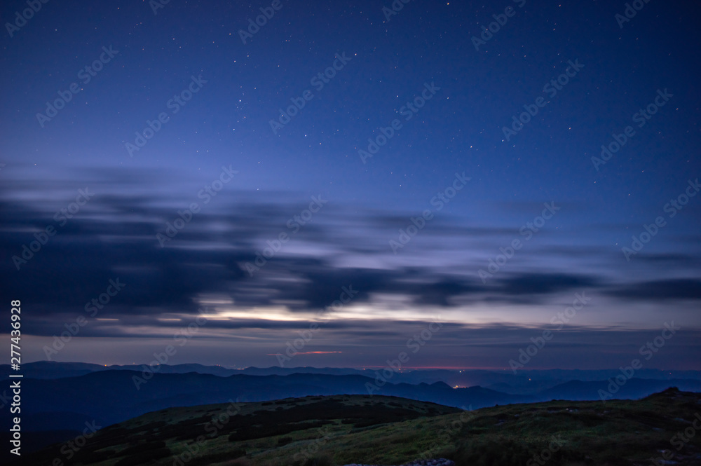 Clouds in the night sky against the background of the Milky Way