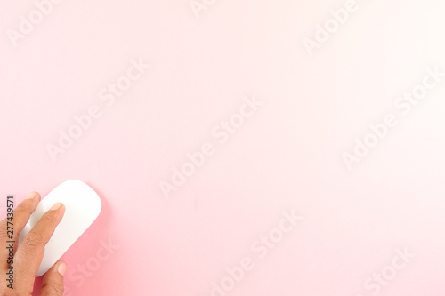 White laptop mouse over pink background.
