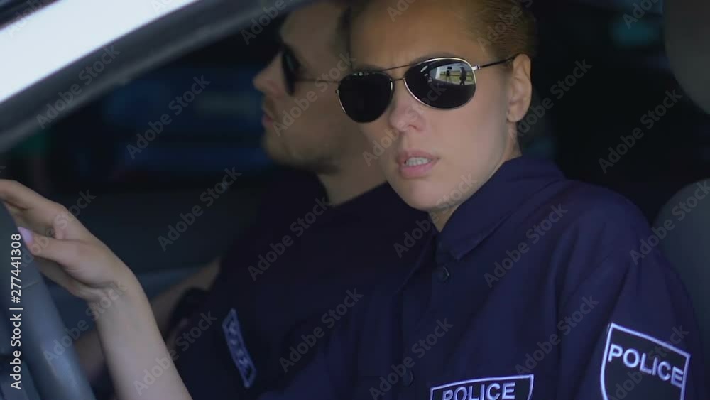Sad police woman and male partner getting in car, depressed about lost criminal Sad police woman and male partner getting in car, depressed about lost criminal
