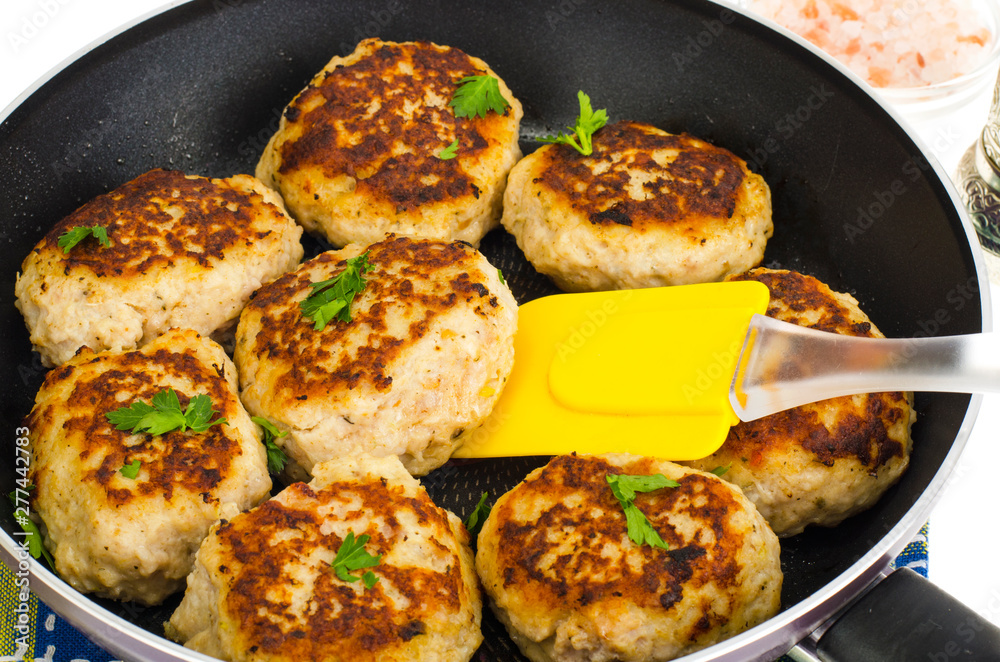 Pan with fried meat patties on white plate Pan with fried meat patties on white plate