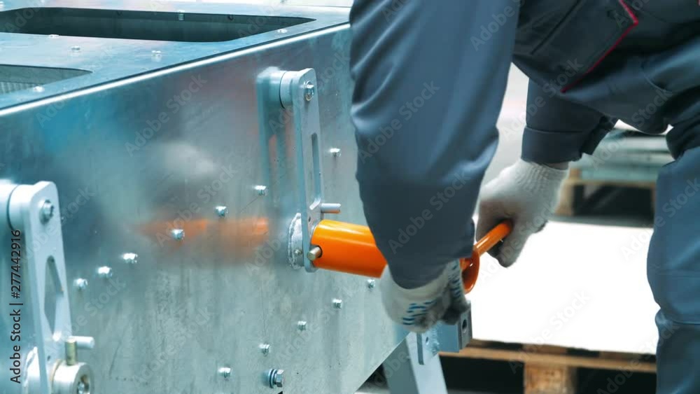 Worker securing bolts with wrench with t-handle. Mechanic tightening bolts Worker securing bolts with wrench with t-handle. Mechanic tightening bolts