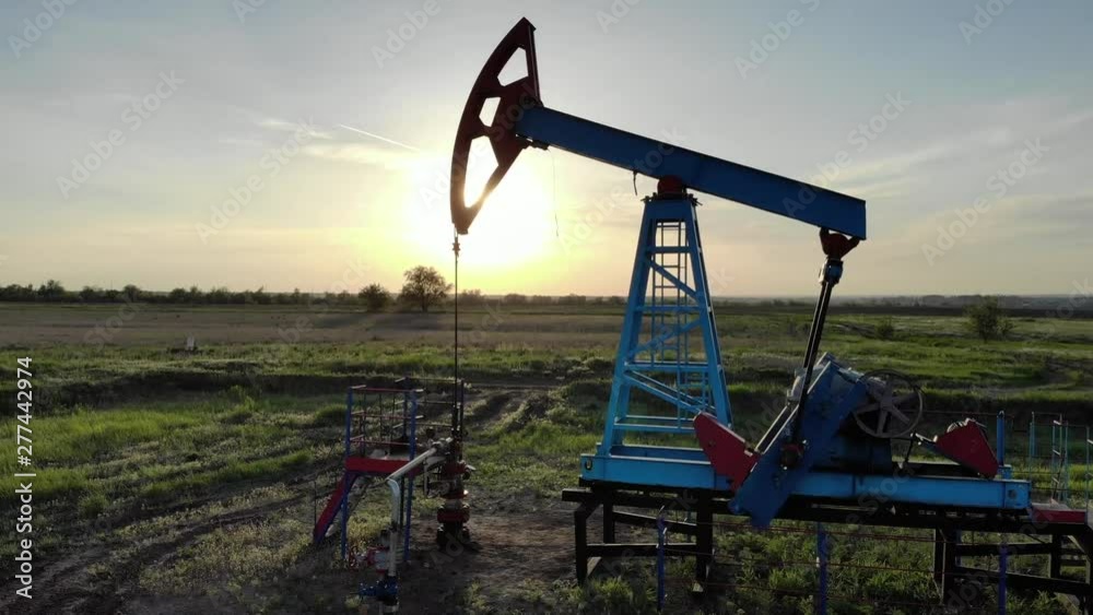 Silhouette of working oil pump from oil field at sunset. The industrial equipment. Silhouette of working oil pump from oil field at sunset. The industrial equipment.
