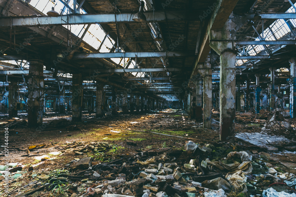 Abandoned ruined industrial warehouse or factory building, corridor view with perspective, ruins and demolition concept