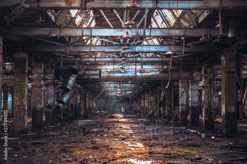 Dramatic ruined and abandoned industrial building, creepy corridor view, perspective