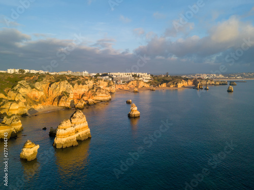 Algarve aerial drone panoramic view. Amazing landscape at sunrise. Beautiful beach near Lagos, Algarve region, Portugal.  Seascape with cliff rocks.