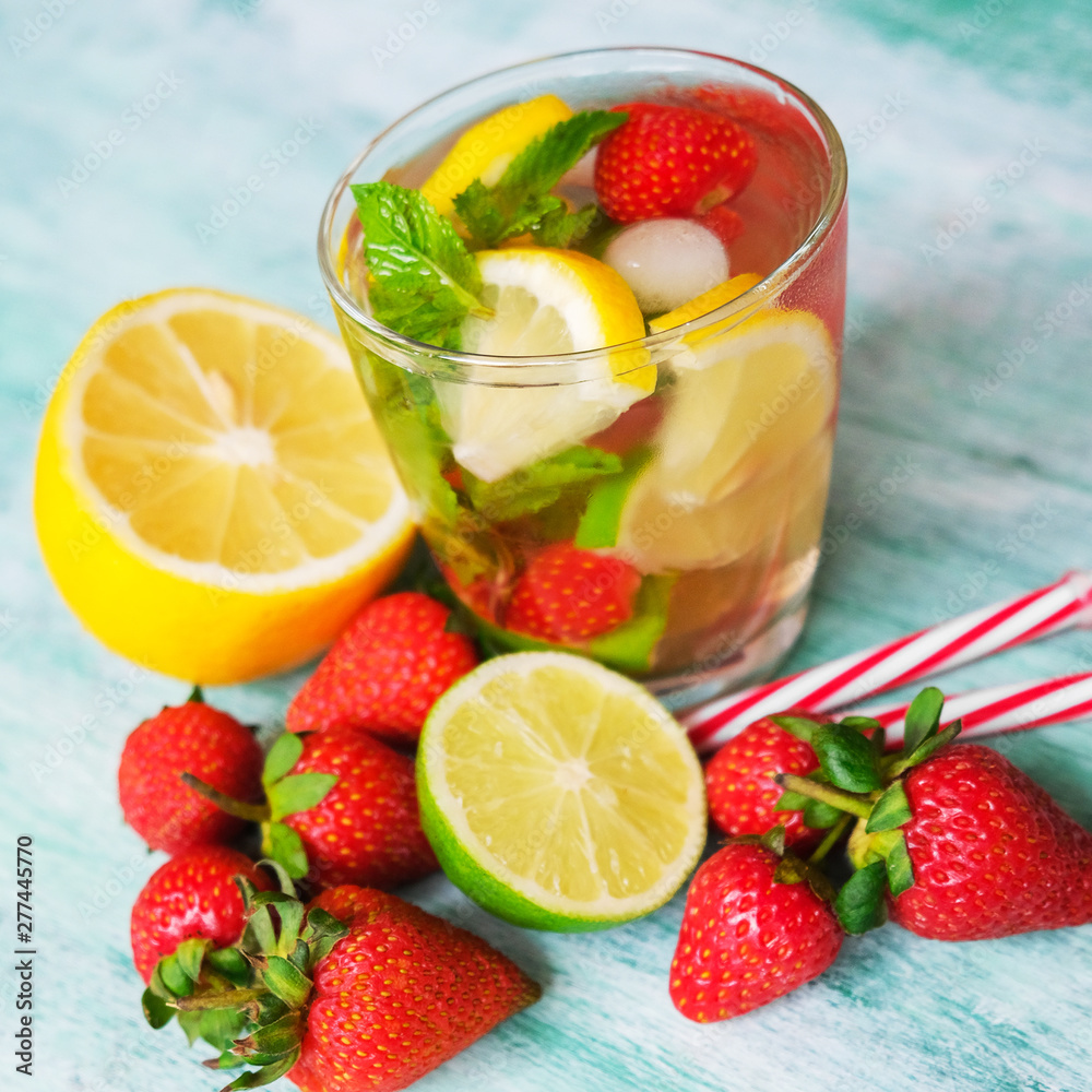 Sweet water with strawberry, mint leaves, lemon and lime. Refreshing summer soft drink with fresh fruits. Sweet water with strawberry, mint leaves, lemon and lime. Refreshing summer soft drink with fresh fruits.
