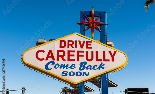 The backside of the famous Las Vegas sign reading "drive carefully, come back soon"