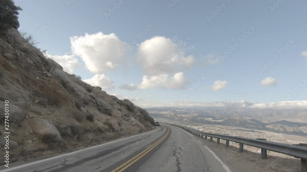 Road in Mountains with View of City Below Road in Mountains with View of City Below