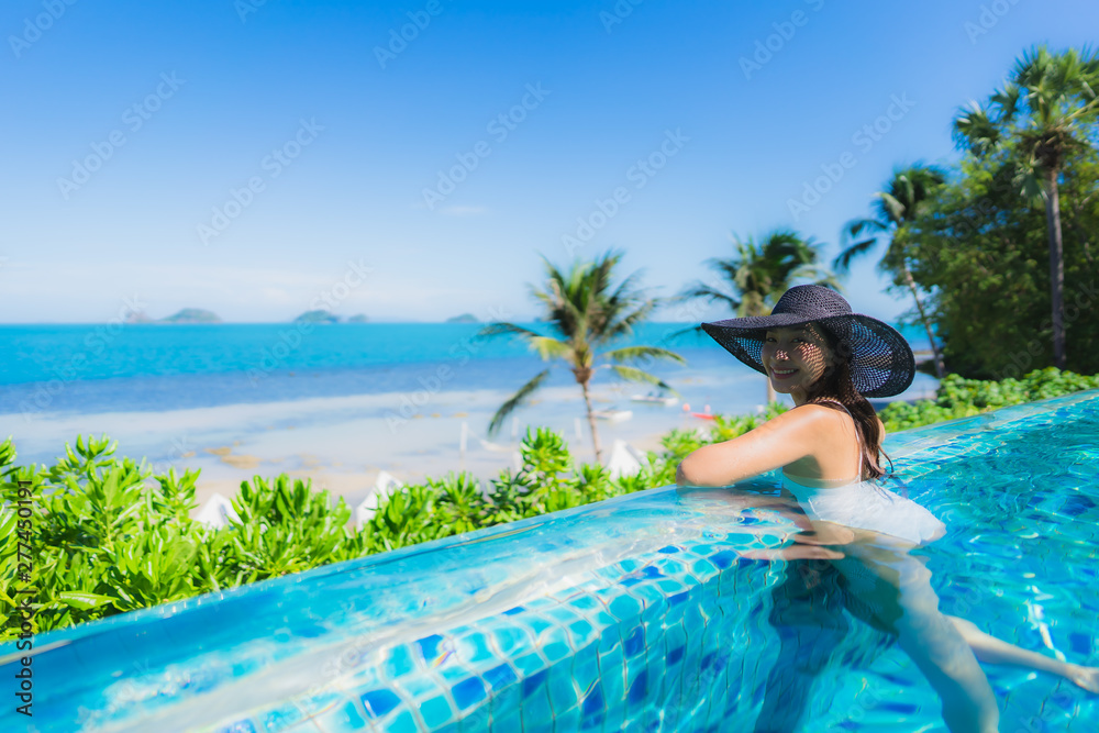 Portrait beautiful young asian woman relax in luxury outdoor swimming pool in hotel resort nearly beach sea ocean Portrait beautiful young asian woman relax in luxury outdoor swimming pool in hotel resort nearly beach sea ocean