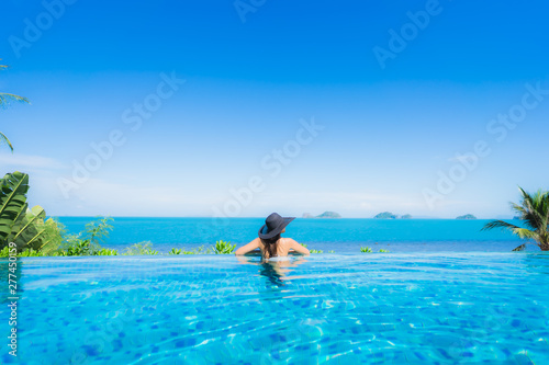 Portrait beautiful young asian woman relax in luxury outdoor swimming pool in hotel resort nearly beach sea ocean © siraphol