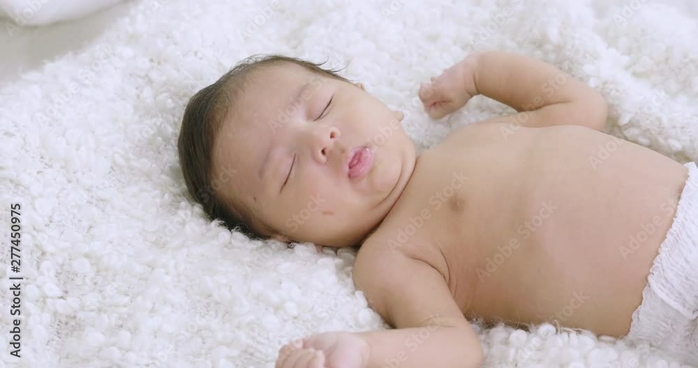 Sweet newborn baby sleeping on bed Sweet newborn baby sleeping on bed