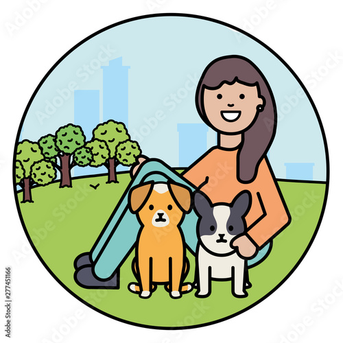 young woman with little dogs in the park
