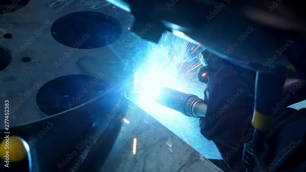 Close-up of welding process with bright sparks. Nozzle of welding machine Close-up of welding process with bright sparks. Nozzle of welding machine