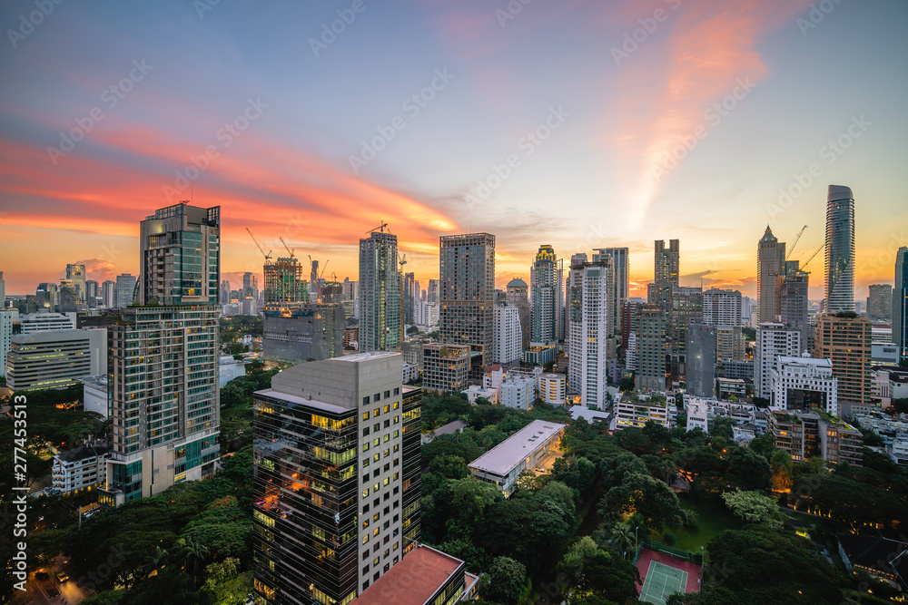 Modern office buildings and condominiums in Bangkok metropolis with sunset sky and clouds at Bangkok , Thailand.