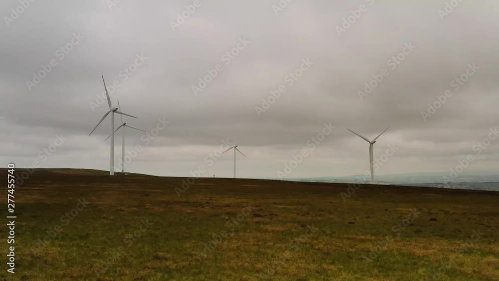 A group of wind turbines on a hill A group of wind turbines on a hill