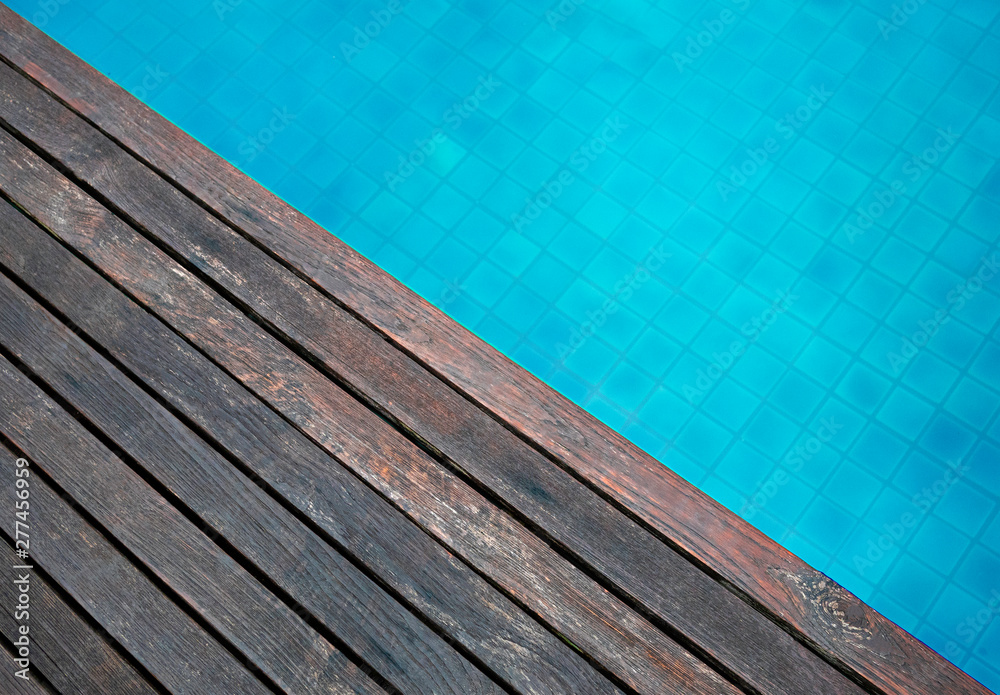 Wooden floor and wave of water in swimming pool in summer day. Wooden floor and wave of water in swimming pool in summer day.