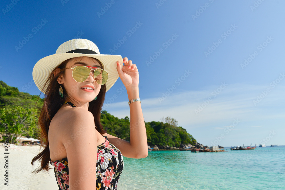 Portrait of young pretty woman at the turquoise sea beach
