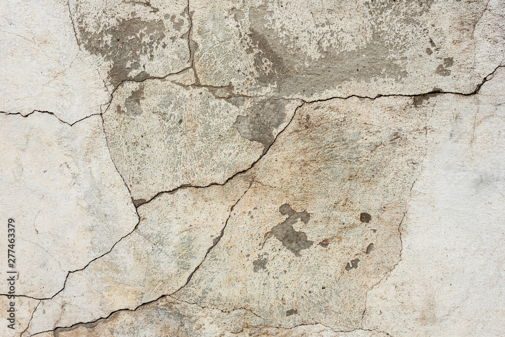 Texture of a concrete wall with cracks and scratches which can be used as a background Texture of a concrete wall with cracks and scratches which can be used as a background
