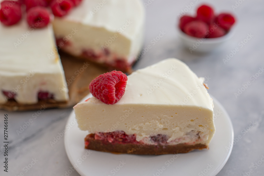Cheesecake slice with raspberries on a plate Cheesecake slice with raspberries on a plate
