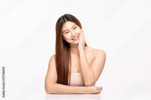 Beautiful Attractive Charming Asian young woman smile with white teeth and touching soft cheek feeling so happy and cheerful with healthy skin,isolated on white background,Beauty Cosmetology Concept