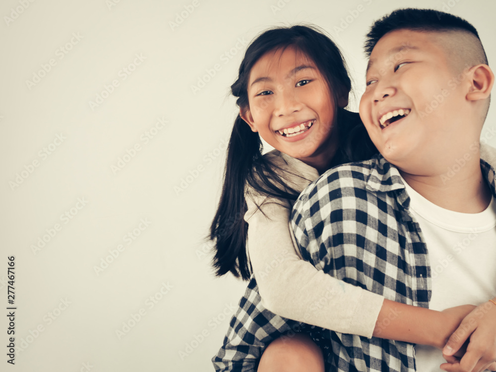 Happy Asian pretty girl enjoying riding on her brother piggyback, lifestyle concept. Happy Asian pretty girl enjoying riding on her brother piggyback, lifestyle concept.