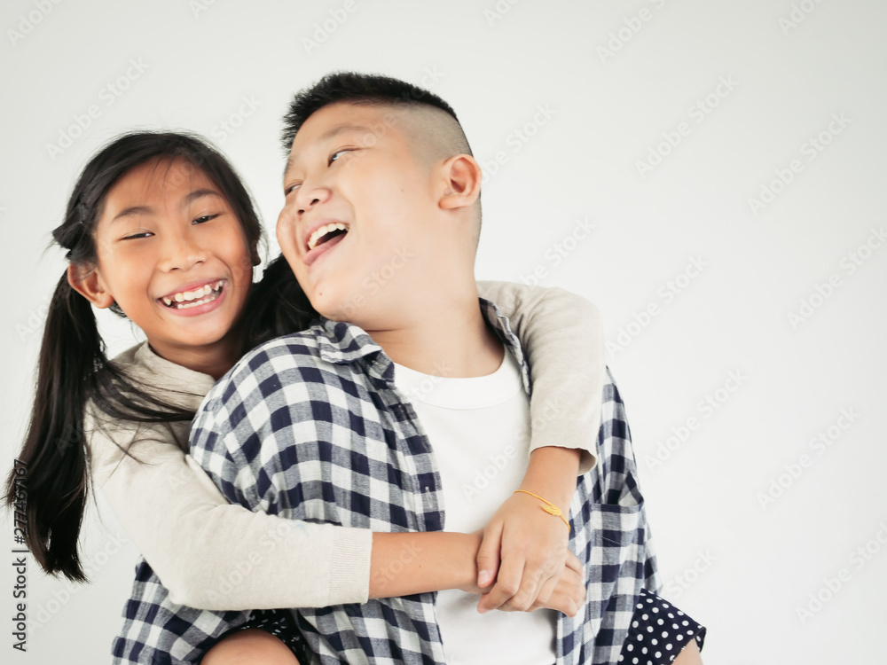 Happy Asian pretty girl enjoying riding on her brother piggyback, lifestyle concept. Happy Asian pretty girl enjoying riding on her brother piggyback, lifestyle concept.