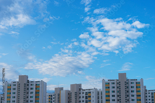 Buildings facade with clean blue sky as background. © SHIMSNAG'S
