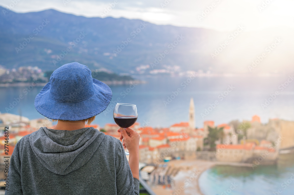Caucasian woman drinking red wine in summer