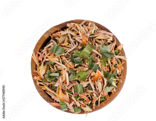 Dried lemongrass leaves in wooden bowl. 