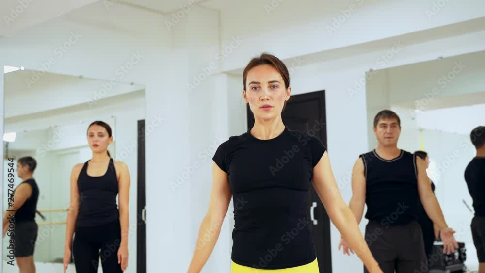 Adult A man and two girls are engaged in Pilates. The system of exercises according to the method of fitness. Adult A man and two girls are engaged in Pilates. The system of exercises according to the method of fitness.