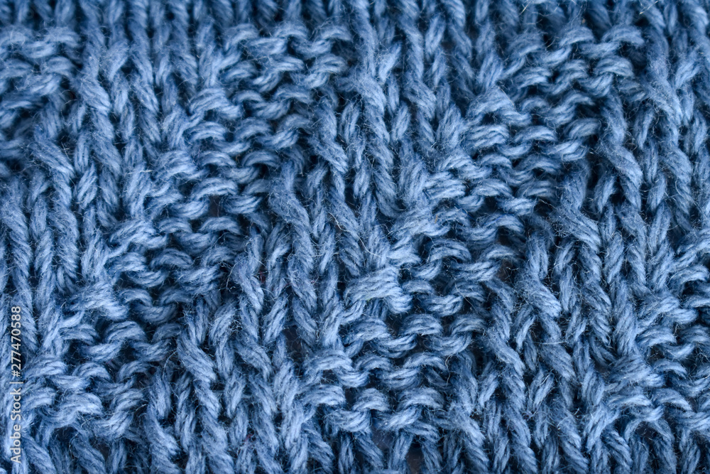 Knitting diagonal pattern of natural blue wool Knitting diagonal pattern of natural blue wool