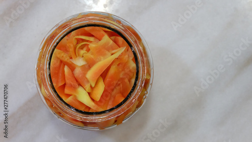 Top view of pickled young papaya in a glass jar. 