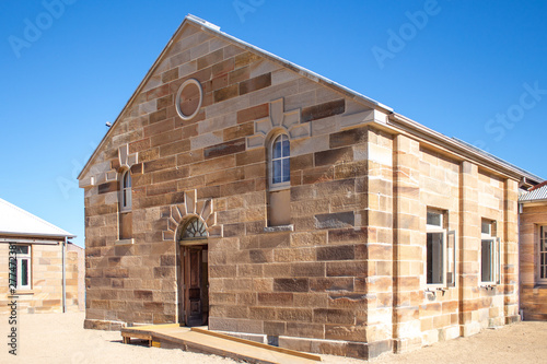 Photography Sandstone brick convict built building with decorative stonework and doorway set