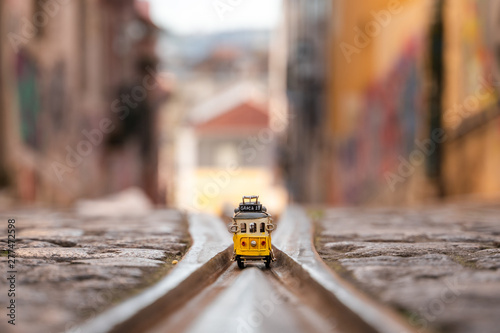 Elevador da Bica: The famous yellow funicular railway line and a miniature train in Lisbon, Portugal. photo