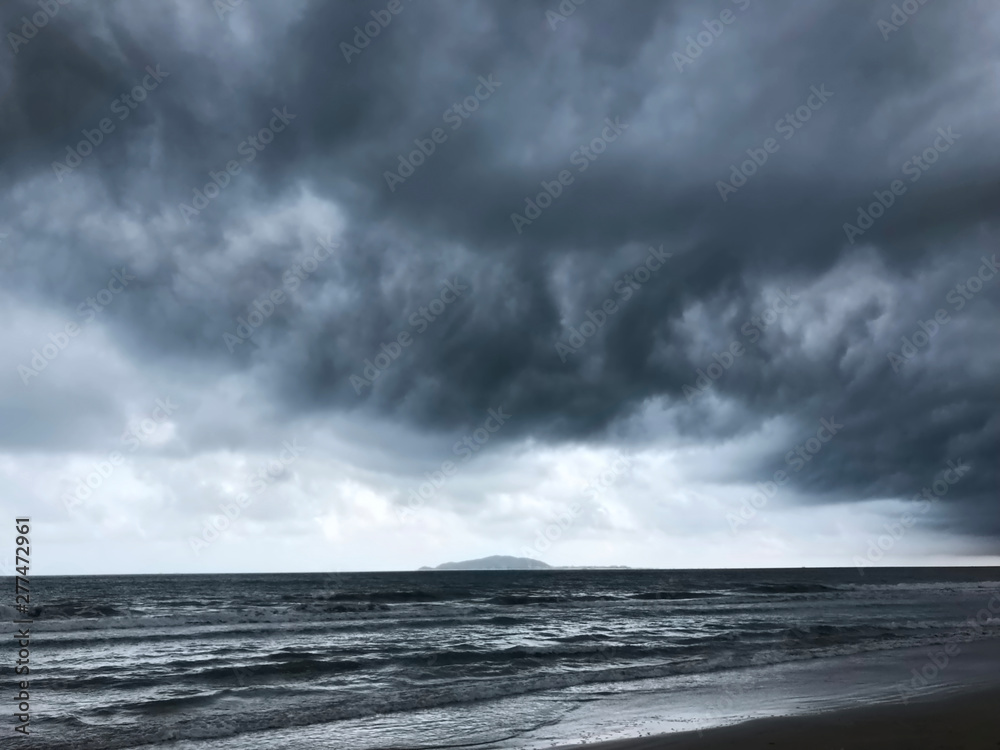 Fototapeta premium background of dramatic heavy dark clouds over the dark beach