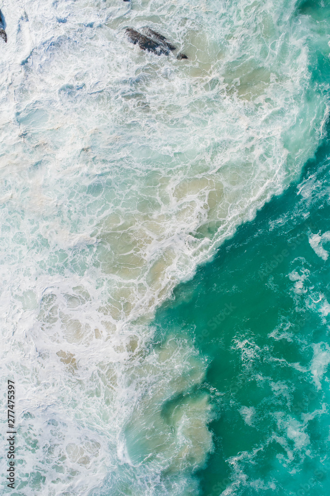 Aerial view of a waves crashing and rolling in the ocean. Aerial view of a waves crashing and rolling in the ocean.