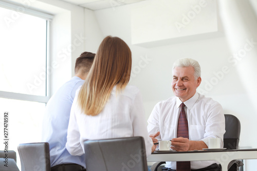 Couple meeting with notary public in office