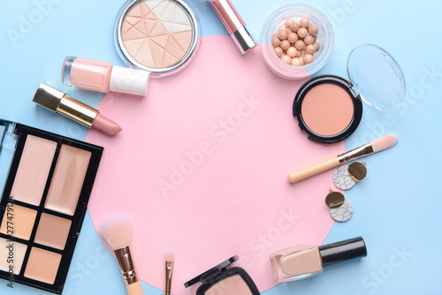 Set of decorative cosmetics and blank card on color background