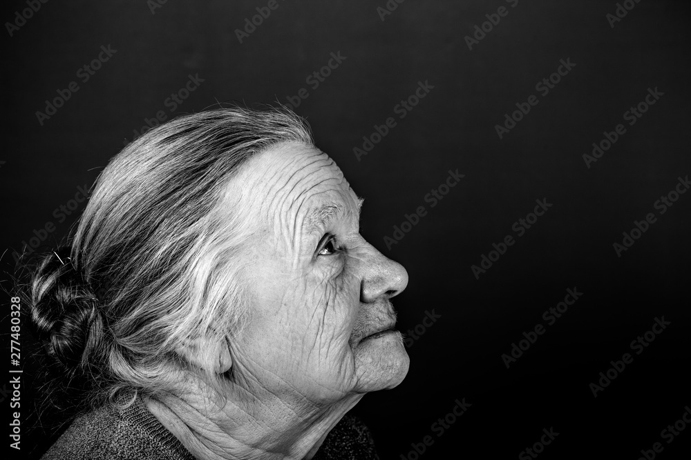 Portrait of elderly woman. Attention. Toned