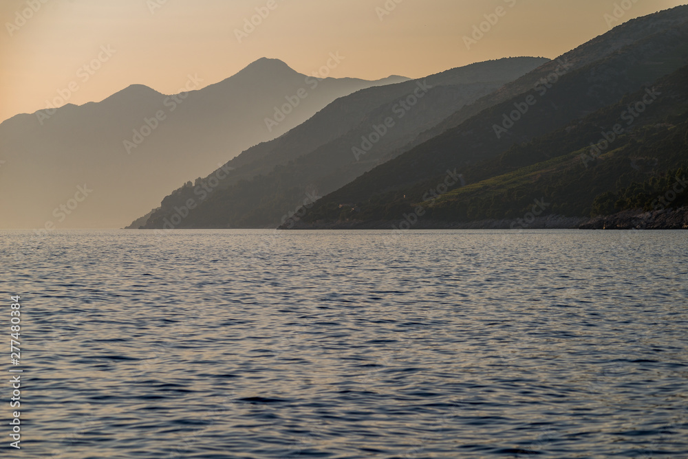 Beautiful sunset with rocks in the Adriatic sea, Dingac Borak, Dalmatia, Croatia, Peljesac peninsula Beautiful sunset with rocks in the Adriatic sea, Dingac Borak, Dalmatia, Croatia, Peljesac peninsula