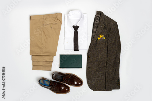 Men's casual outfits for man clothing set wit suit, shirt, book and shoes isolated on white background, Top view. pack shot
