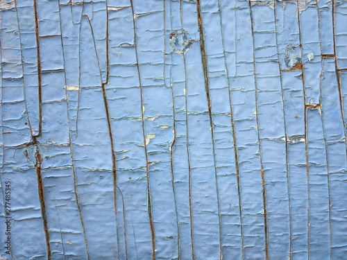 old wooden surface with cracked blue paint
