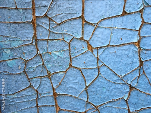old blue wooden background with peeling paint