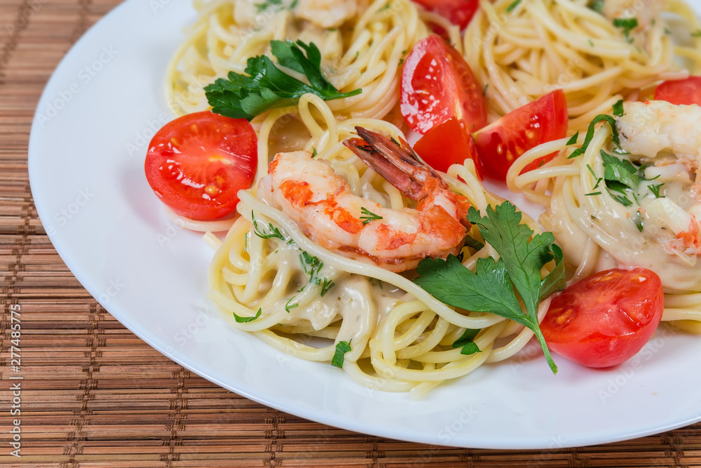 Cooked Spaghetti pasta with shrimp tails and cherry tomatoes closeup Cooked Spaghetti pasta with shrimp tails and cherry tomatoes closeup