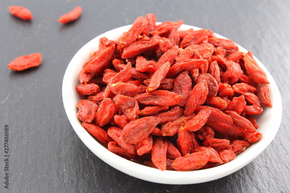 dried goji berries in a small white bowl dried goji berries in a small white bowl