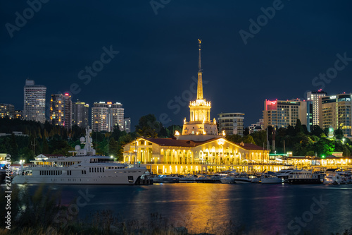 Sochi sea port. Evening illumination of the building. Attraction of the resort city. Parking for yachts and ships. City view.