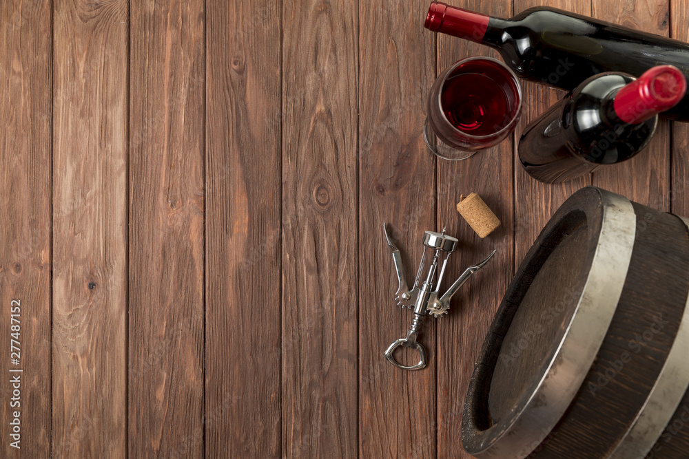 Fototapeta premium Top view wine bottles on wooden background