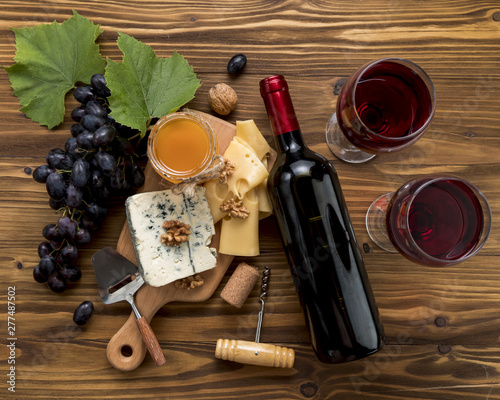 Wine with food on wooden background